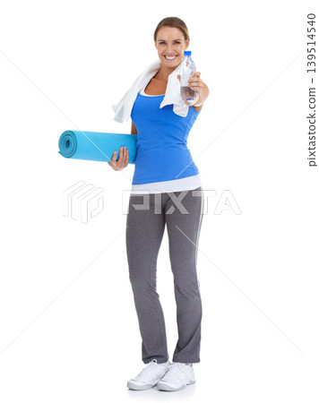 Yoga mat, water and portrait of woman in studio for exercise, training or workout. Happy, equipment and young female person with hydration drink for fitness or sports isolated by white background. Yoga mat, water and portrait of woman in studio for exercise, training or workout. Happy, equipment and young female person with hydration drink for fitness or sports isolated by white background. 139514540