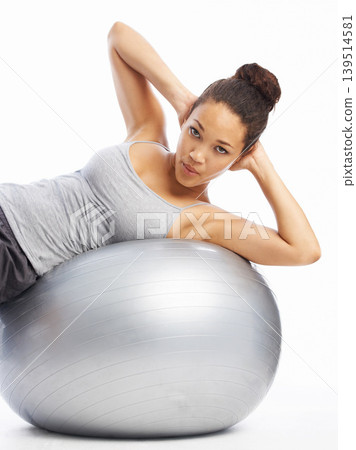 Woman, portrait and exercise ball in pilates for core strength, fitness or workout against a white studio background. Female person or athlete training on round object, gym equipment or body stretch Woman, portrait and exercise ball in pilates for core strength, fitness or workout against a white studio background. Female person or athlete training on round object, gym equipment or body stretch 139514581