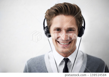 Business man, portrait and headphones for music, smile and listening to radio by wall background. Employee, person and happy with sound, hearing and audio streaming subscription for podcast with tech 139514584