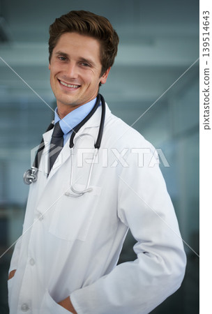 Smile, pride and portrait of man doctor with stethoscope for positive, good and confident attitude. Happy, career and professional young male healthcare worker in medical office of hospital or clinic 139514643