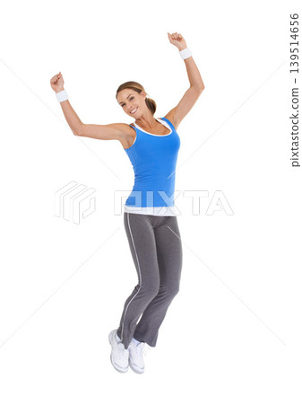 Woman, jump and fitness celebration in studio for exercise success, workout achievement or body goals and dance. Sports model with fist, energy and portrait for training results on a white background Woman, jump and fitness celebration in studio for exercise success, workout achievement or body goals and dance. Sports model with fist, energy and portrait for training results on a white background 139514656