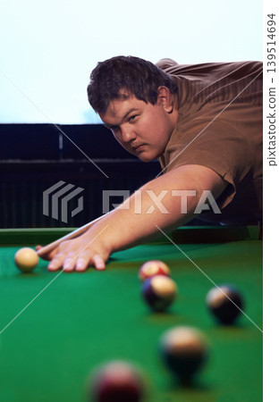 Man playing pool, game and aim with cue and ball, social event at sports bar or restaurant for contest. Competition, focus and serious player, billiard or snooker with concentration for target in pub Man playing pool, game and aim with cue and ball, social event at sports bar or restaurant for contest. Competition, focus and serious player, billiard or snooker with concentration for target in pub 139514694