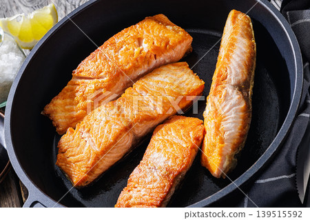Pan-seared salmon fillets on a skillet, close-up 139515592