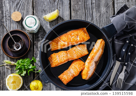 Pan-seared salmon fillets on a skillet, close-up Pan-seared salmon fillets on a skillet, close-up 139515598