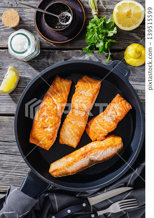 Pan-seared salmon fillets on a skillet, close-up Pan-seared salmon fillets on a skillet, close-up 139515599