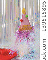 A birthday party hat and dazzling aurora-colored decorations. 139515895