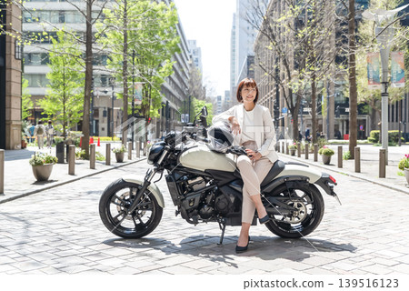 Female rider on a motorcycle in Marunouchi Female rider on a motorcycle in Marunouchi 139516123