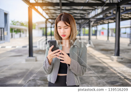 asian businesswoman use smartphone for working or shopping online outdoor asian businesswoman use smartphone for working or shopping online outdoor 139516209