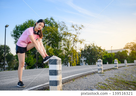 attractive asian woman healthy jogging exercise with headphones in park outdoor attractive asian woman healthy jogging exercise with headphones in park outdoor 139516321