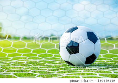 Soccer Ball in Goal, Football Scoring, Winning Sports Concept Soccer Ball in Goal, Football Scoring, Winning Sports Concept 139516356