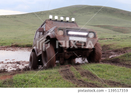 Jeep off road in muddy conditions 139517359