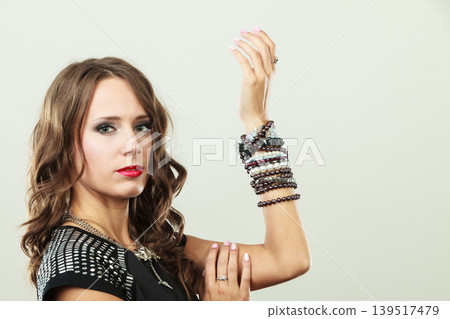 Elegant woman wearing multiple bracelets Elegant woman wearing multiple bracelets 139517479