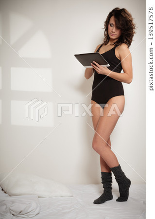 Sexy lazy girl with tablet touchpad in bedroom Sexy lazy girl with tablet touchpad in bedroom 139517578