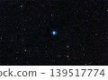 Celestial blue reflection nebula glowing brightly amidst a rich field of distant stars across the cosmos. 139517774