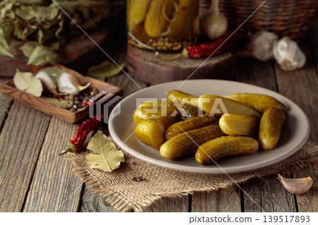 Homemade canned gherkins on a rustic wooden background. 139517893