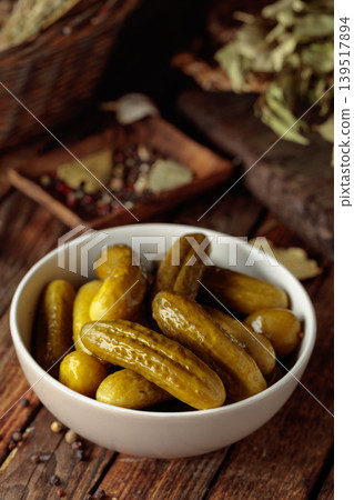 Homemade canned gherkins on a rustic wooden background. Homemade canned gherkins on a rustic wooden background. 139517894