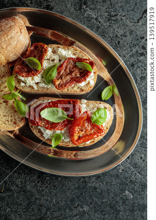Ciabatta with sun dried tomatoes in olive oil, ricotta and basil. Ciabatta with sun dried tomatoes in olive oil, ricotta and basil. 139517919