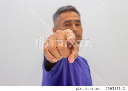 Man pointing finger with stern serious expression. Angry guy selecting someone. Accusation or target selection concept. Critical attitude and confrontation, nonverbal communication and gesture. Man pointing finger with stern serious expression. Angry guy selecting someone. Accusation or target selection concept. Critical attitude and confrontation, nonverbal communication and gesture. 139518142