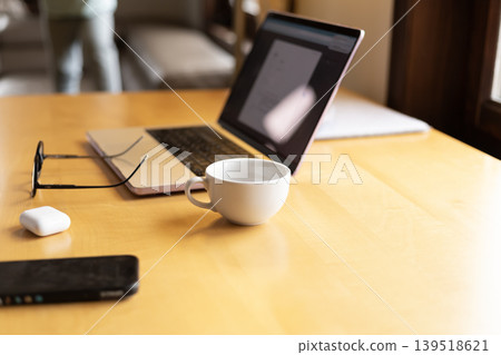 Laptop coffee cup eyeglasses and accessories on wooden desk Laptop coffee cup eyeglasses and accessories on wooden desk 139518621