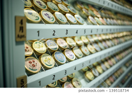 Hand creams tins with colorful designs are arranged on shelves Hand creams tins with colorful designs are arranged on shelves 139518734