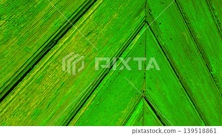 Close-up of aged wooden planks with heavily peeling bright blue paint arranged in a geometric chevron pattern. Vintage rustic texture concept 139518861