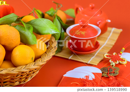 Basket oranges with tea set on table for festive occasion during Chinese New Year celebration Basket oranges with tea set on table for festive occasion during Chinese New Year celebration 139518990