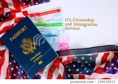 Documents related to citizenship immigration with US passport, flags on display at table Documents related to citizenship immigration with US passport, flags on display at table 139519013