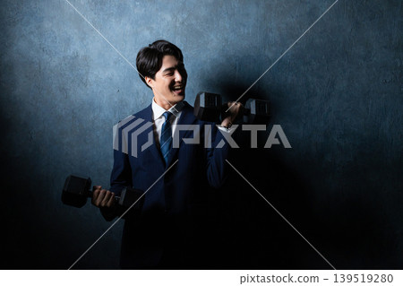 A businessman with a dumbbell A businessman with a dumbbell 139519280