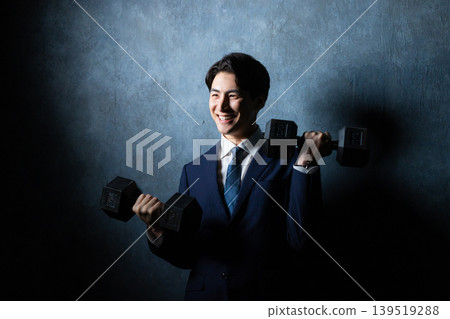 A businessman with a dumbbell A businessman with a dumbbell 139519288