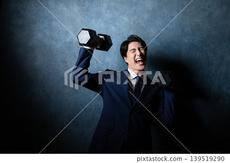 A businessman with a dumbbell 139519290