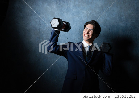 A businessman with a dumbbell A businessman with a dumbbell 139519292