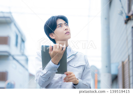 Workers inspecting air conditioners Workers inspecting air conditioners 139519415