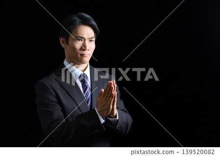 Businessman, man, suit, hands clasped in prayer, praying, requesting, apologizing, praying to God, offering prayers, joining hands, asking, pleading, serious Businessman, man, suit, hands clasped in prayer, praying, requesting, apologizing, praying to God, offering prayers, joining hands, asking, pleading, serious 139520082