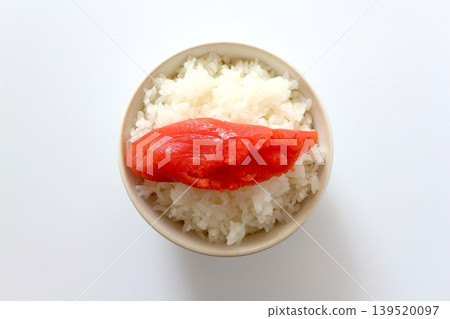 White rice and cod roe in a bowl, viewed from directly above against a white background. 139520097
