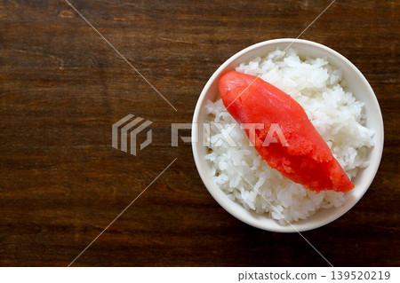 White rice and cod roe in a bowl, viewed from directly above the table background. White rice and cod roe in a bowl, viewed from directly above the table background. 139520219