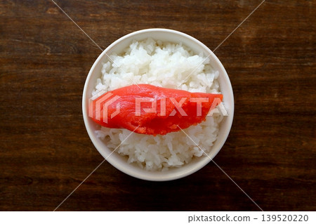 White rice and cod roe in a bowl, viewed from directly above the table background. White rice and cod roe in a bowl, viewed from directly above the table background. 139520220