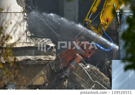 Construction site: Commercial building being demolished by heavy machinery. Construction site: Commercial building being demolished by heavy machinery. 139520551