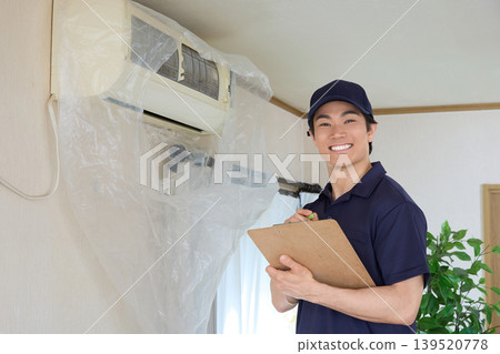 Cleaning staff inspecting a household air conditioner 139520778