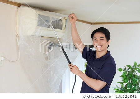 Smiling air conditioner cleaning staff (indoor work) Smiling air conditioner cleaning staff (indoor work) 139520841