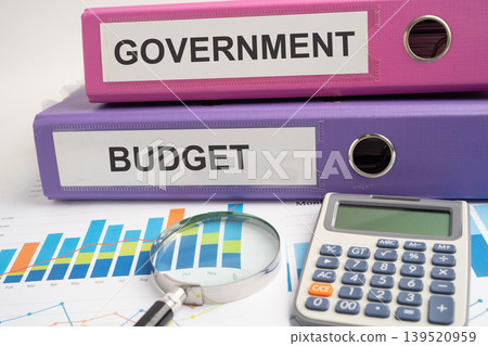 Payroll Overtime, binder with graph and calculator at office. Payroll Overtime, binder with graph and calculator at office. 139520959