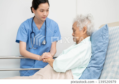 Asian doctor checking and treat elderly woman patient health in hospital. Asian doctor checking and treat elderly woman patient health in hospital. 139520979
