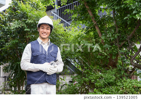 A gardener holding pruning shears A gardener holding pruning shears 139521005