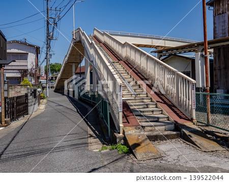 A pedestrian overpass with a bicycle ramp and the blue sky 139522044