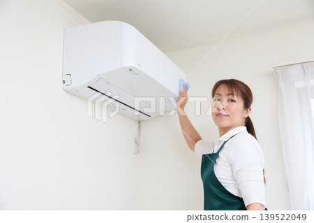 House cleaning staff cleaning air conditioners House cleaning staff cleaning air conditioners 139522049
