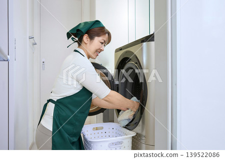 Housekeeping staff taking out the laundry Housekeeping staff taking out the laundry 139522086