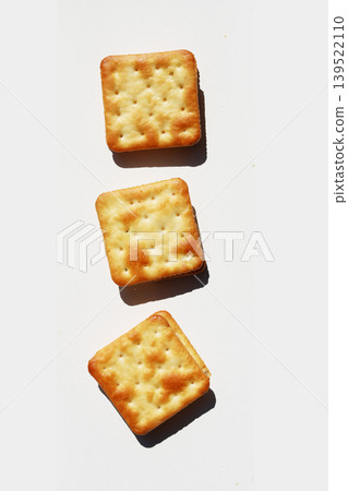 Golden crispy crackers isolated on white background Golden crispy crackers isolated on white background 139522110
