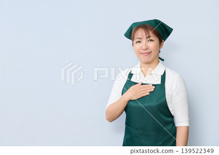 A house cleaning staff member places their hand on their chest. A house cleaning staff member places their hand on their chest. 139522349