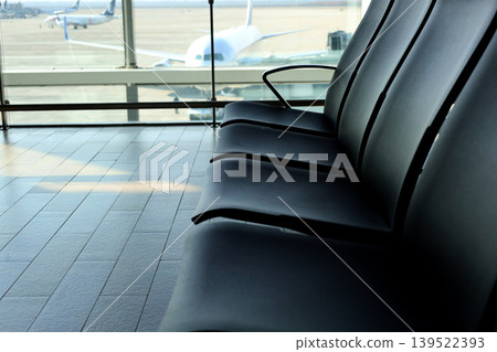 Empty airport waiting chairs near window Empty airport waiting chairs near window 139522393