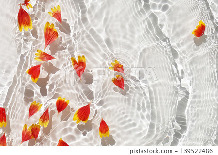 Gaillardia flower petals floating on clear water with soft ripples. 139522486