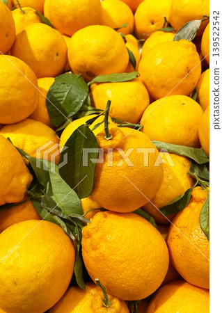 Fresh oranges with green leaves at fruit market Fresh oranges with green leaves at fruit market 139522542